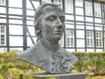 Die Büste von Dr. med. Johann Erhard Trampel befindet sich im Kurpark in Horn-Bad Meinberg. Auf dem Schild vor der Büste ist zu lesen: "Dr. Johann E. Trampel / 1737-1817 / Hofmedicus / Erster Brunnenarzt im Curort Meinberg"